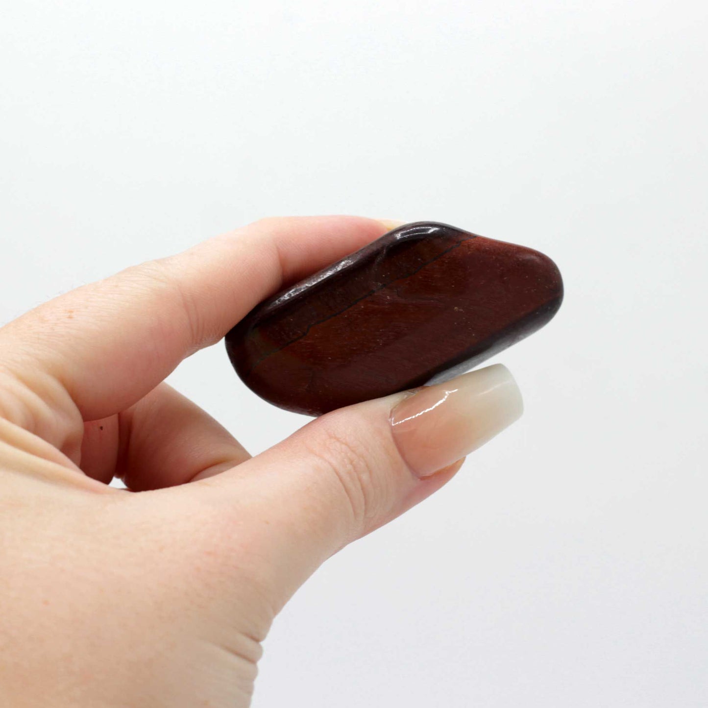 Beutel mit 6 großen afrikanischen Trommelsteinen - Rotes Tigerauge - ca. 8–30 mm