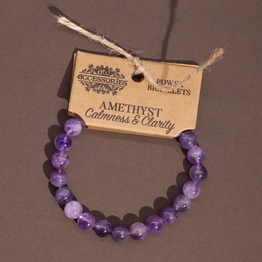 Edelstein-Kraftarmband Amethyst – auf braunem Untergrund