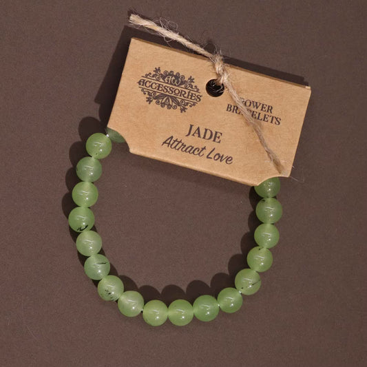 Edelstein-Kraftarmband Jade – auf braunem Untergrund