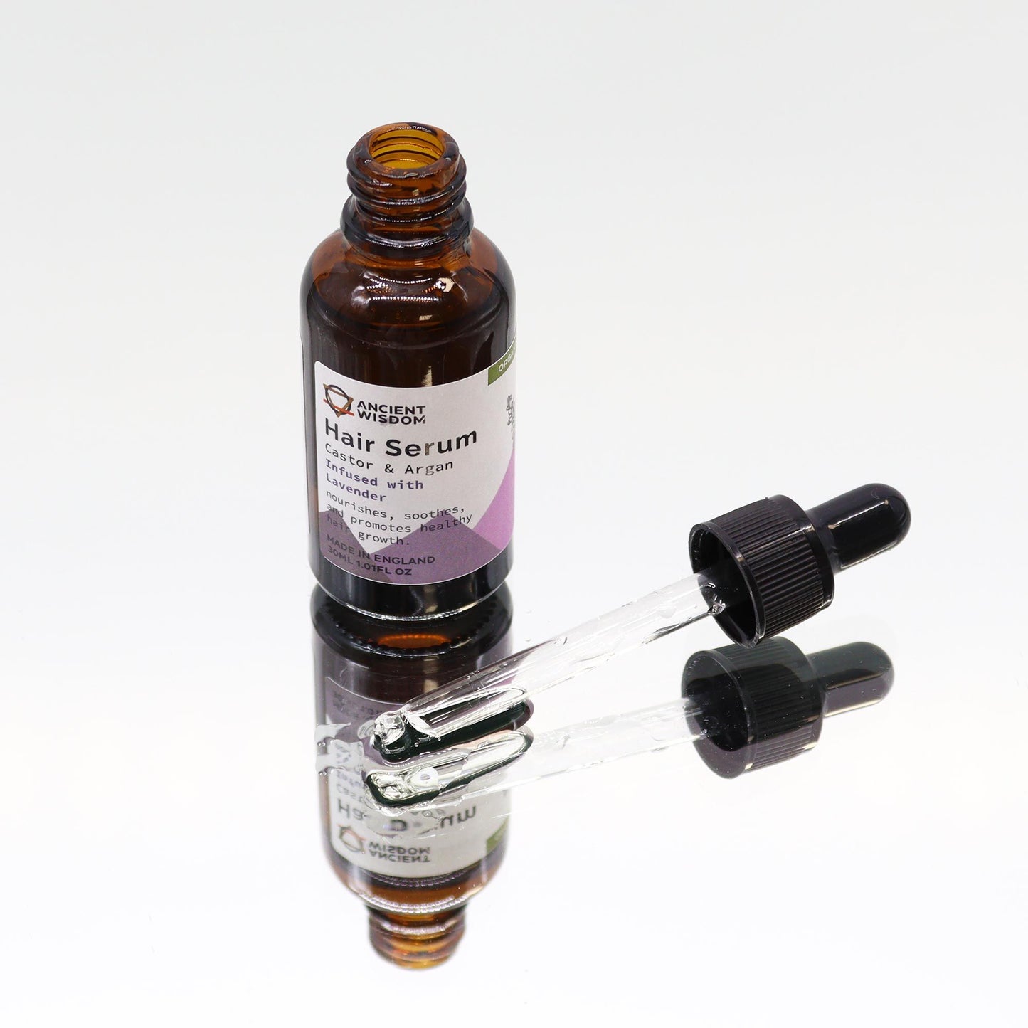 Haarserum Lavendel – Glasflasche auf Spiegel, Tropfer daneben