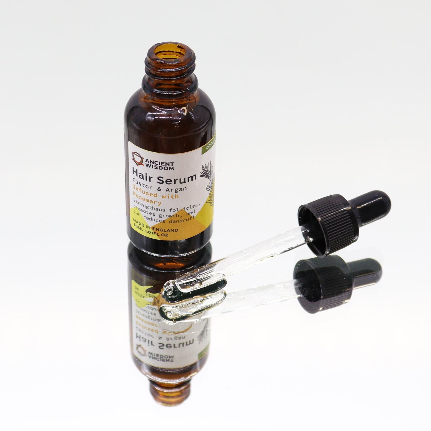 Haarserum Rosmarin – Glasflasche auf Spiegel, Tropfer daneben